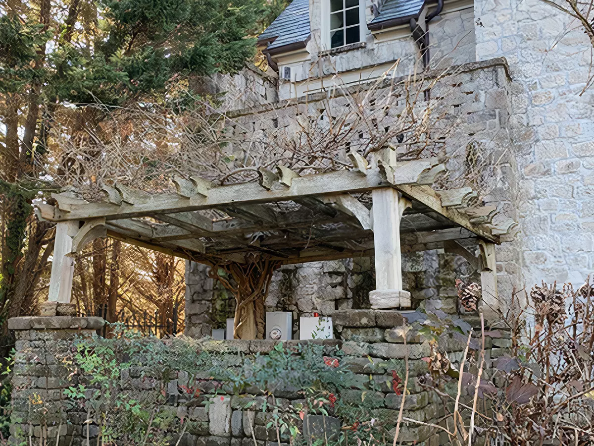 Old rotten pergola on an older stone house