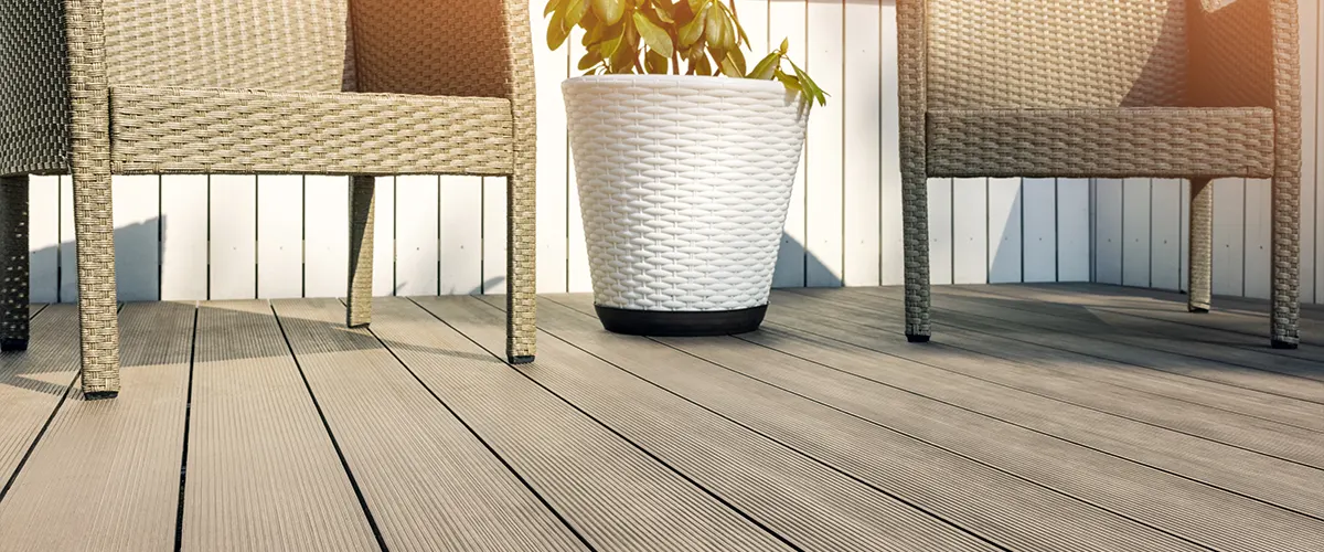 Trex decking prices in 2022 with a transcend Trex on a deck with two chairs and a plant