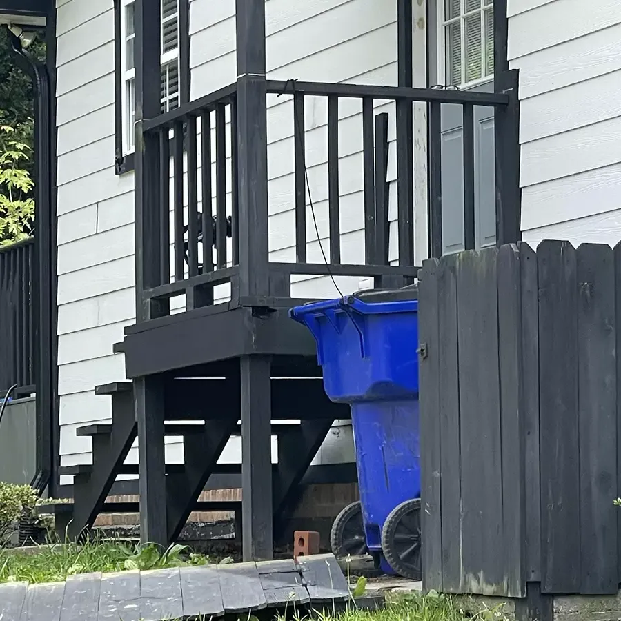 Small backyard exit deck with old fence