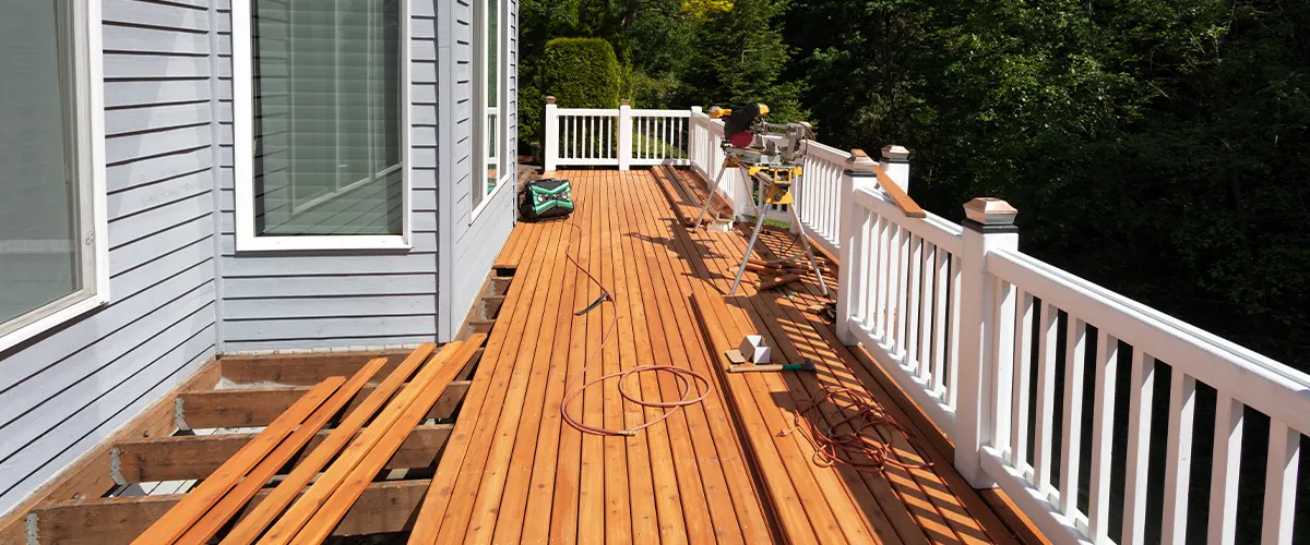 Replacing deck boards on a deck attached to a house