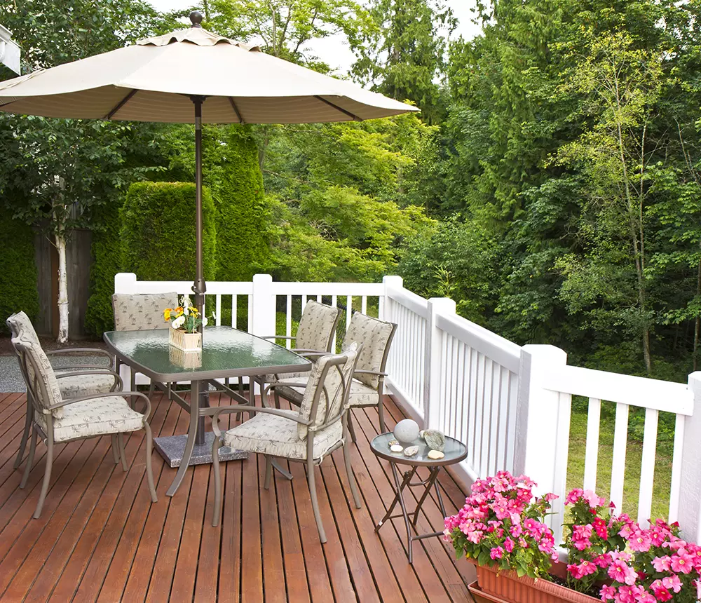 Table with six chairs on a deck with white railing in Knoxville, Tennessee