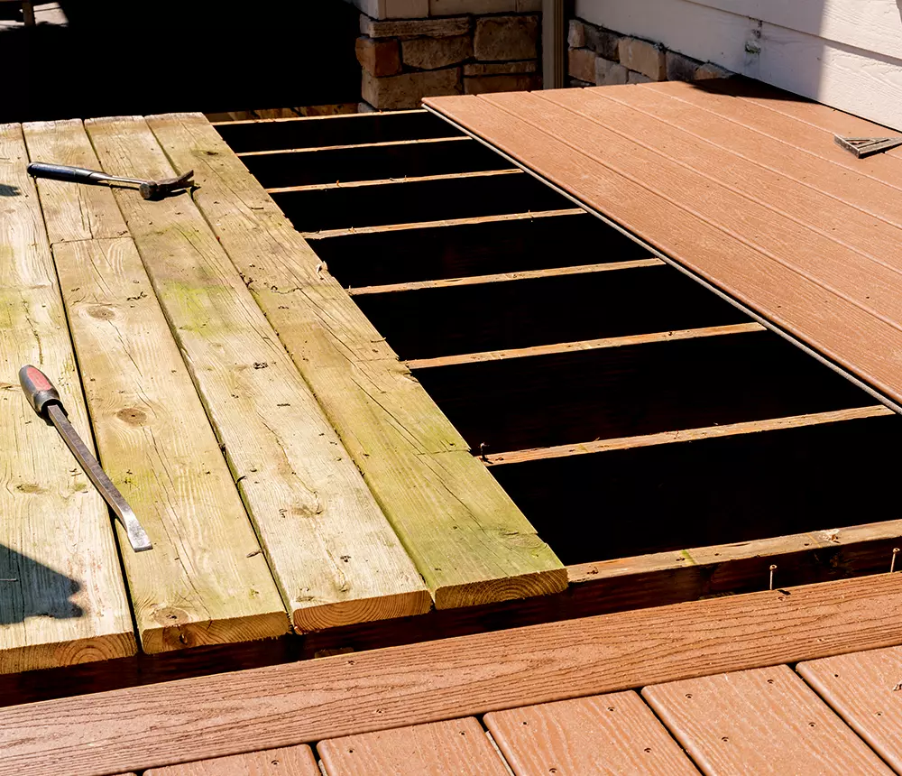 Process of replacing wooden deck boards with composite decking materials for a deck repair project in Tennesee