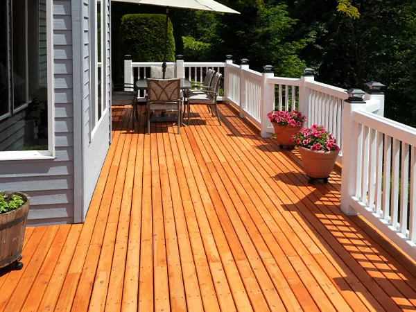 A wood deck with a white railing