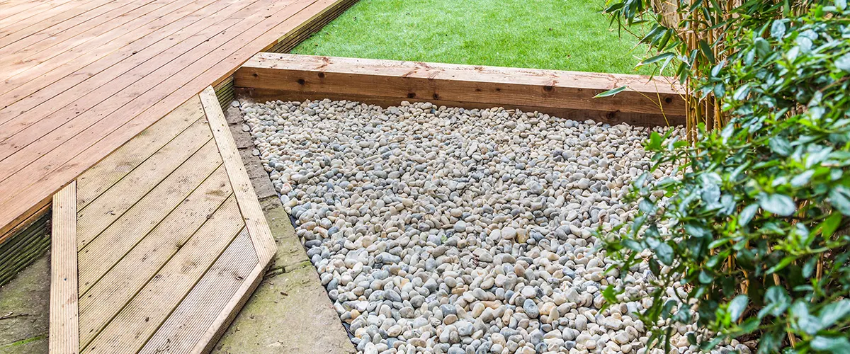 Building a deck over concrete with gravel and a patch of grass