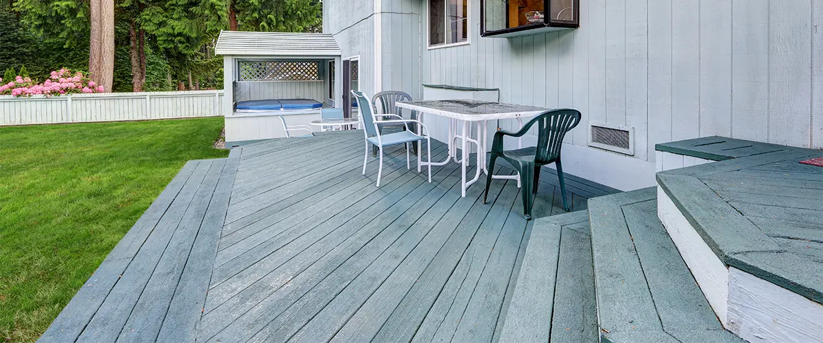A gray deck on ground-level