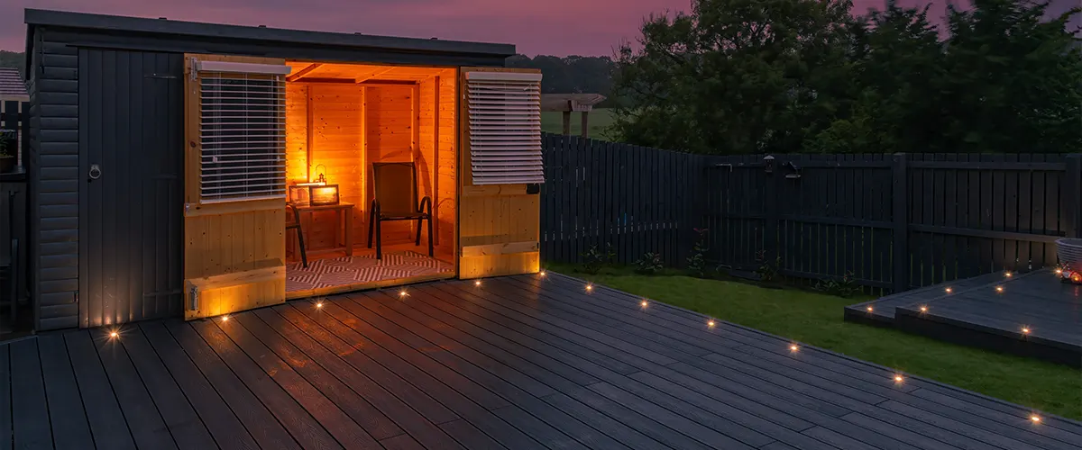 Deck lighting on a freestanding deck with a shed