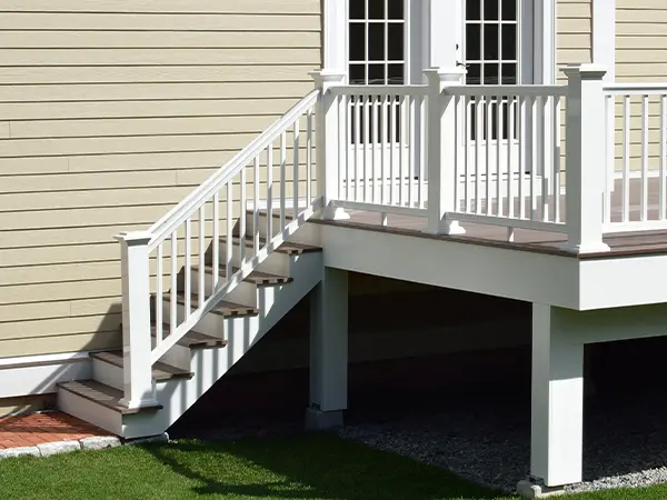 Wood railing painted white for an elevated deck