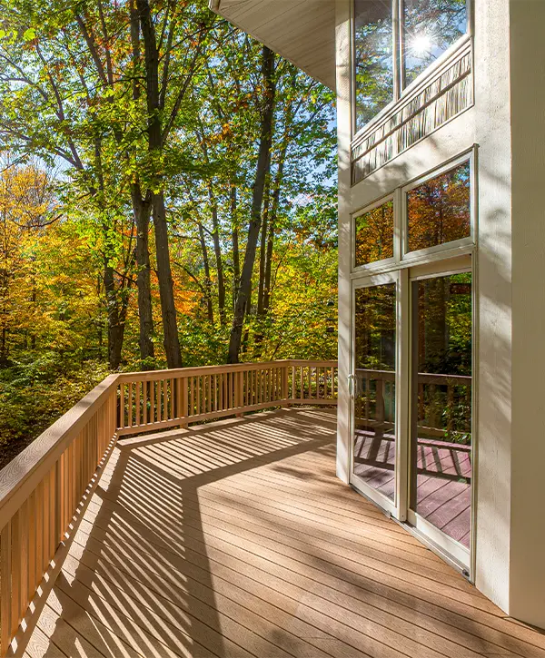 A composite deck with composite railing on the side of a home