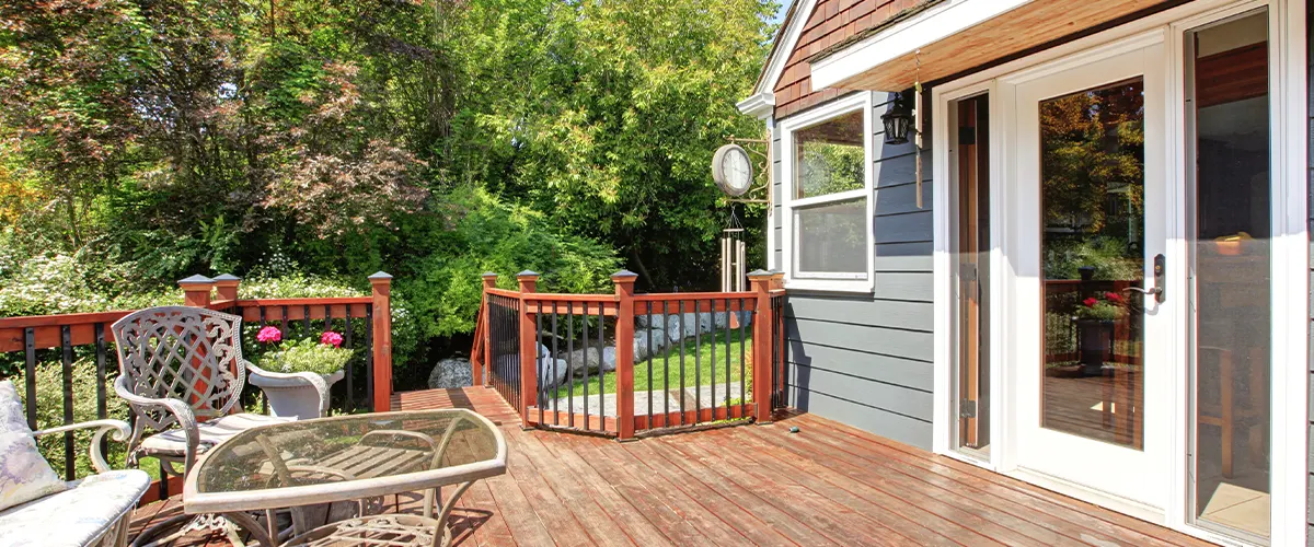 wood deck attached to home with railings