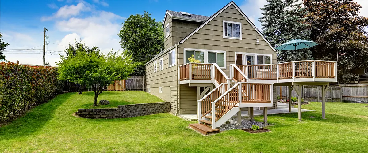 A home with a two-story deck on a large patch of grass