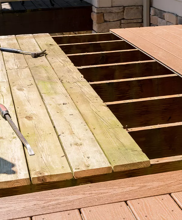 deck Replacement of old wooden deck with composite material outdoor in the sun with tools on the deck