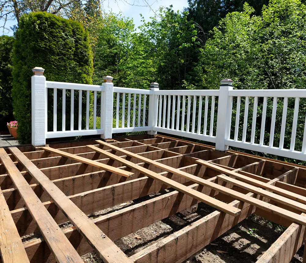 deck replacement for a cedar deck with new boards and white railings