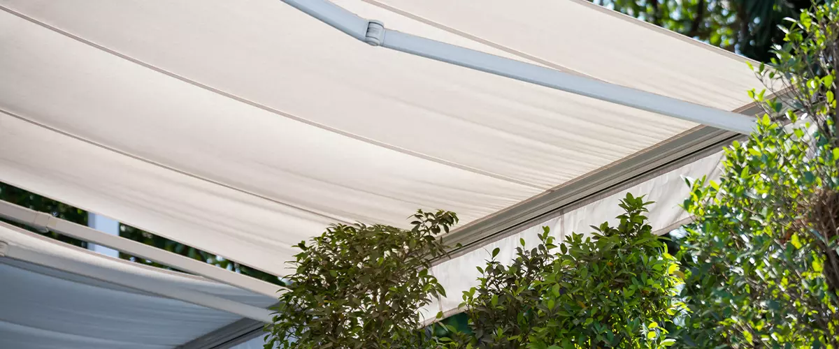 white awning in garden. canvas shading.