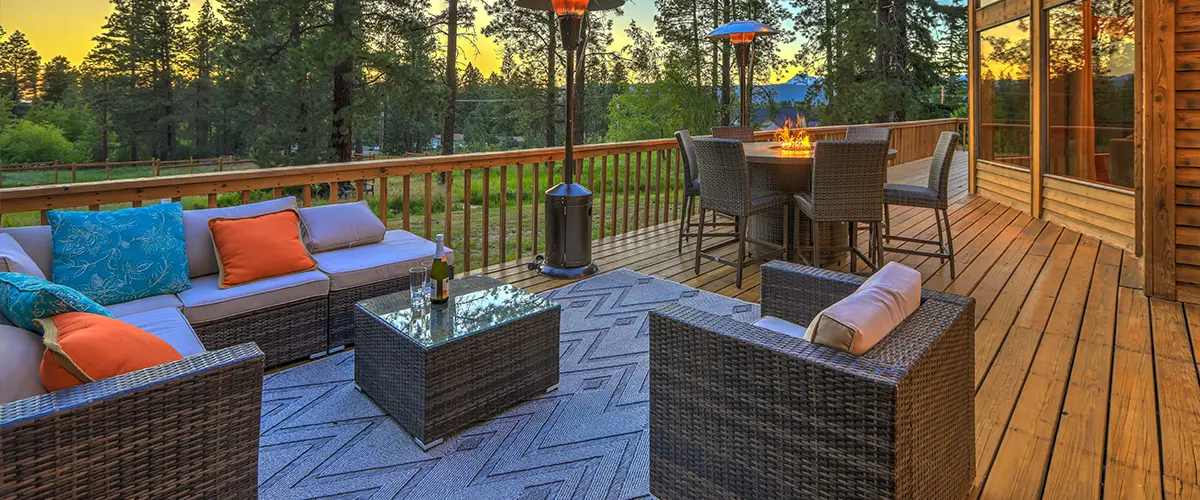 Cozy deck in Powell, TN with modern furniture and forest view, perfect for serene evenings.