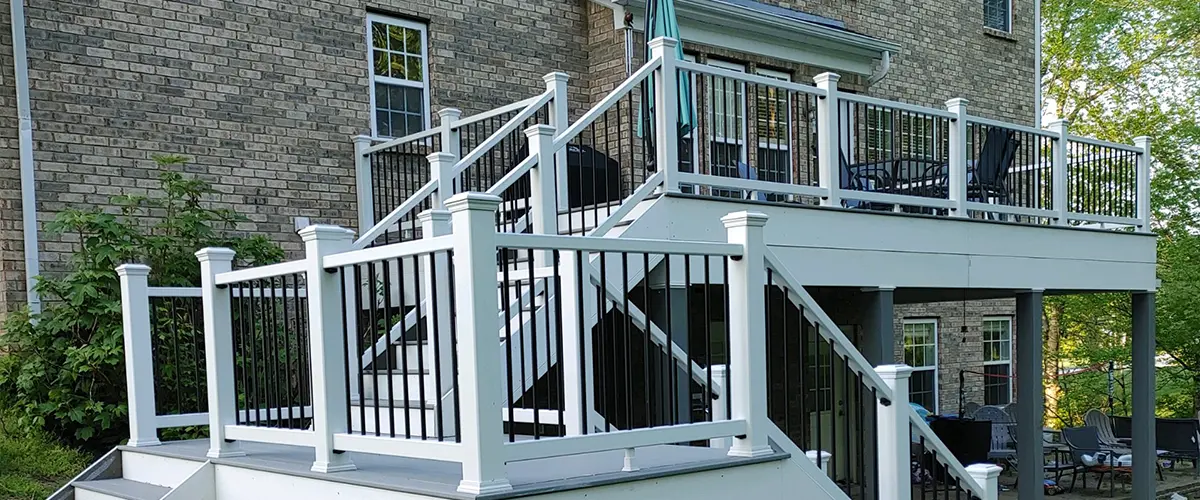 Closeup of deck building with white vinyl handrails, two-story deck in Seymour, TN