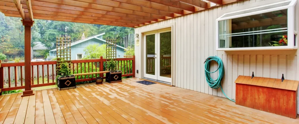 Covered deck with wooden flooring and outdoor storage