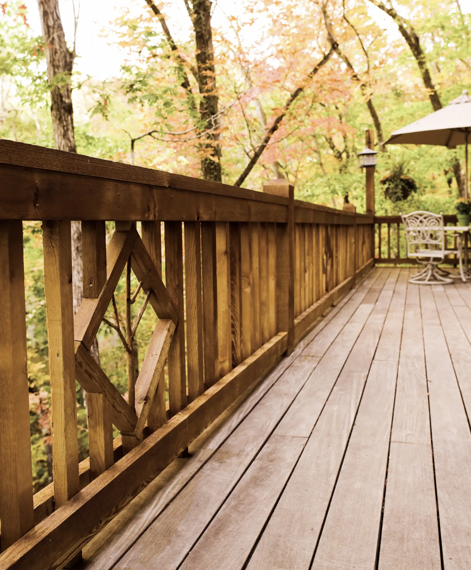 Close-up of composite decking with wooden chairs on a sunny day