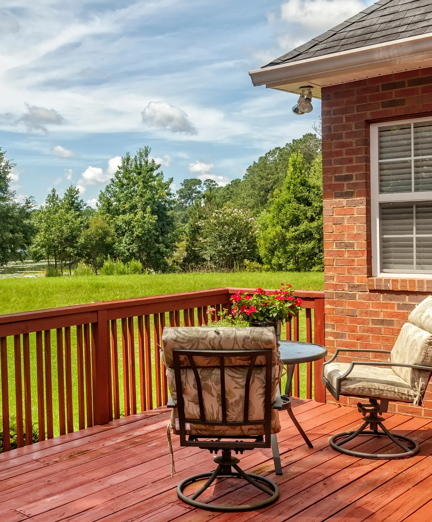 Luxury outdoor deck with elegant seating and lush greenery