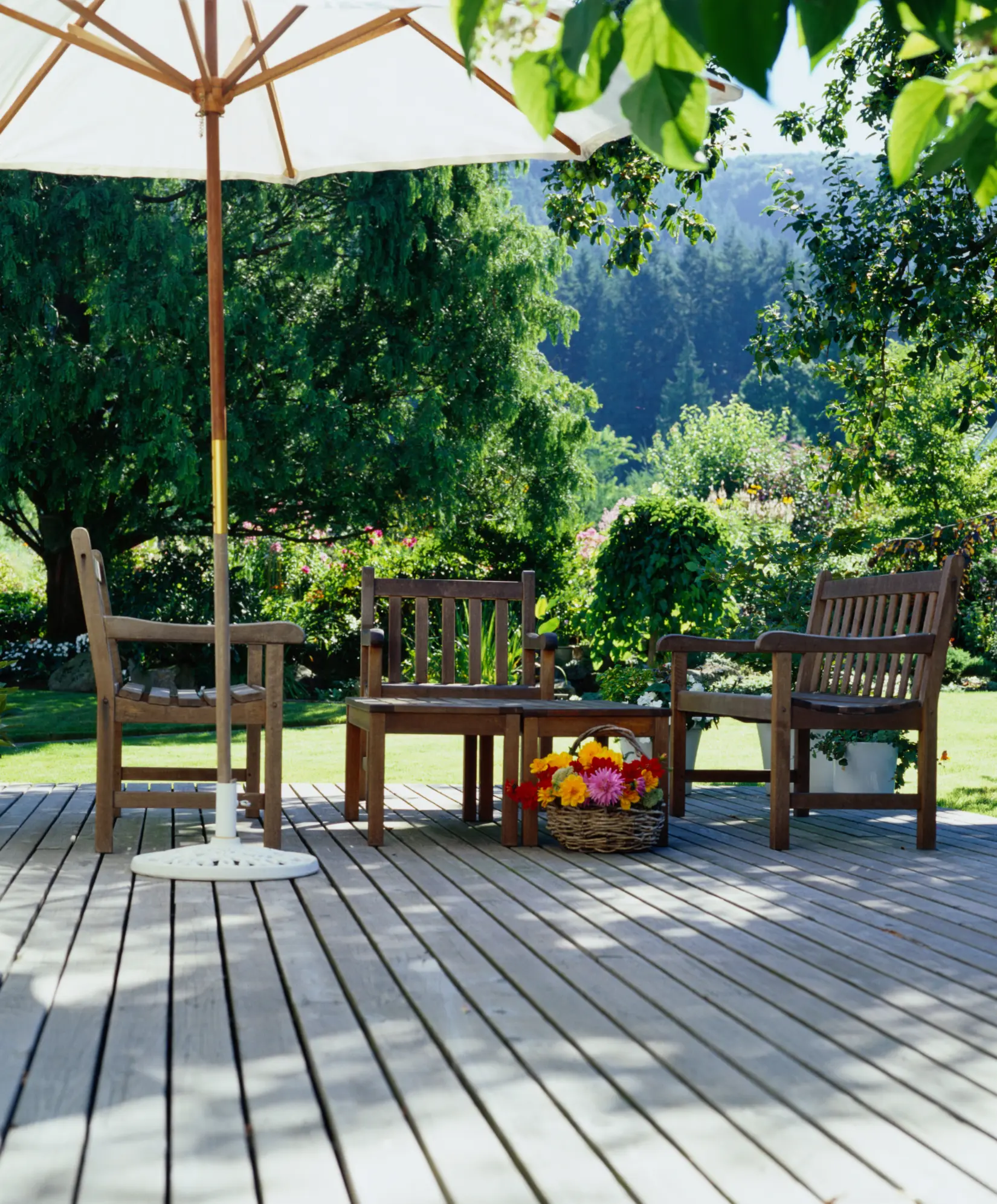 Cozy garden patio with wooden deck and umbrella-shaded seating