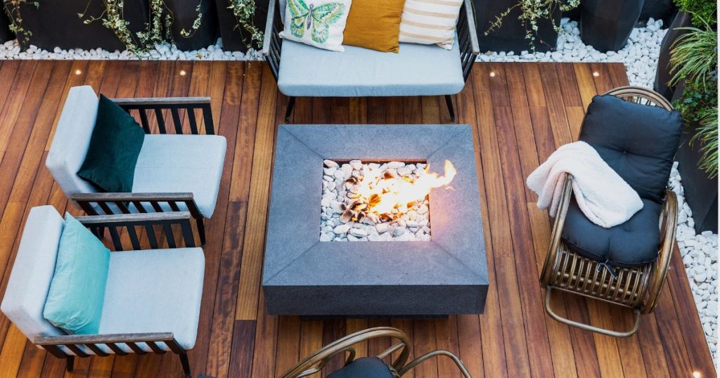 Modern outdoor deck with a fire pit and lounge seating