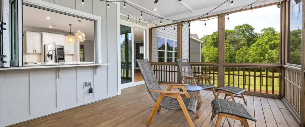 Cozy covered porch with wooden deck and outdoor seating