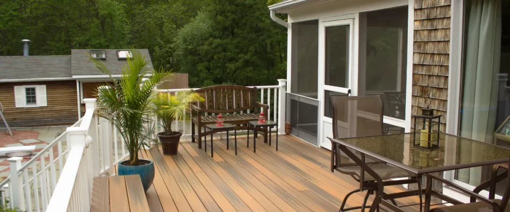 Wooden deck with patio furniture and a screened-in porch