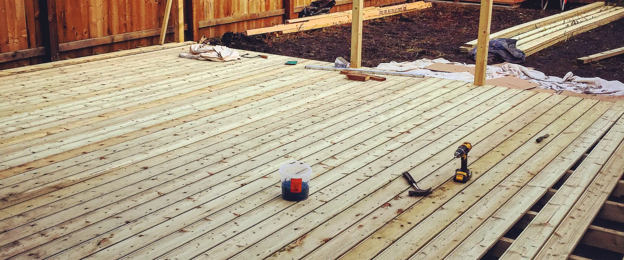 Newly constructed wooden deck with tools and materials scattered around