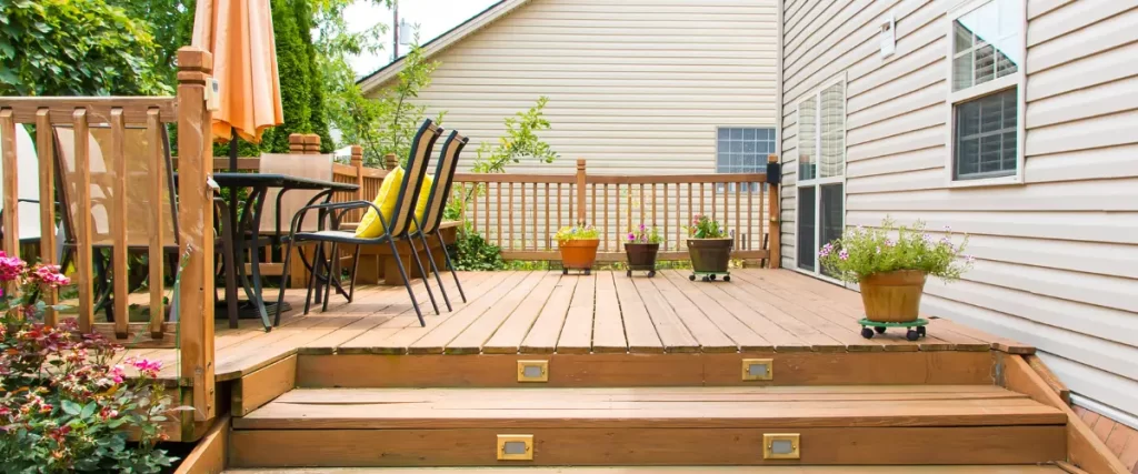 Wood deck with outdoor dining furniture and potted plants