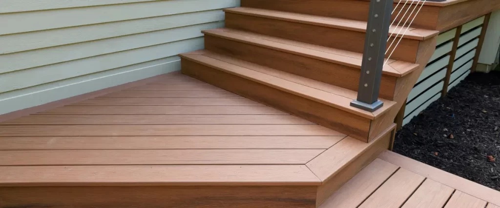 Composite deck stairs with clean, angular design and cable railing