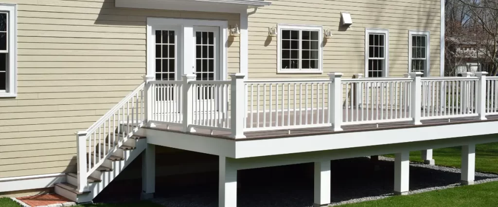 Side view of elevated deck with white railings and staircase