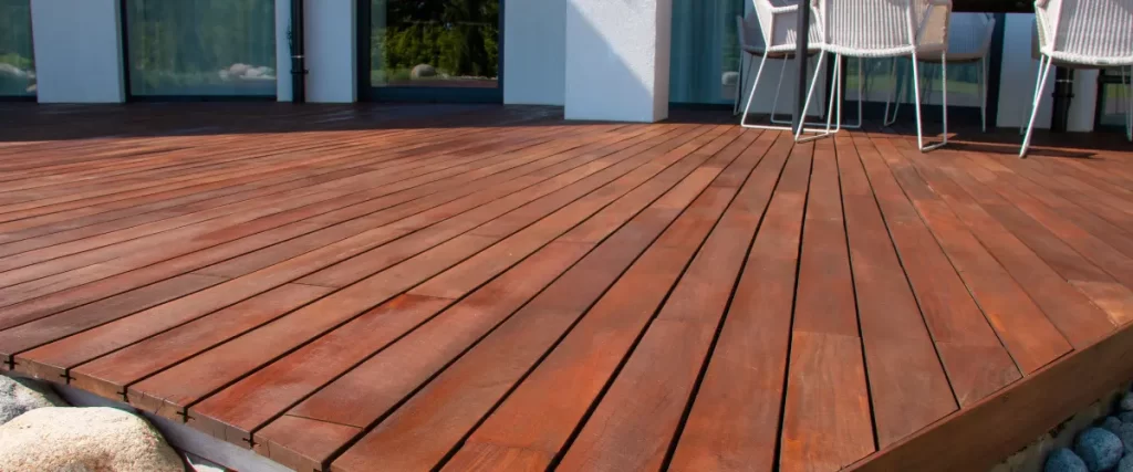 Close-up view of hardwood deck boards connected to modern home
