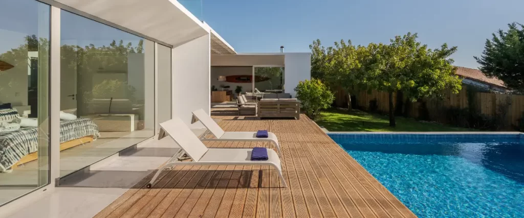 A villa featuring spacious, open-plan living areas that lead directly onto the wooden pool deck
