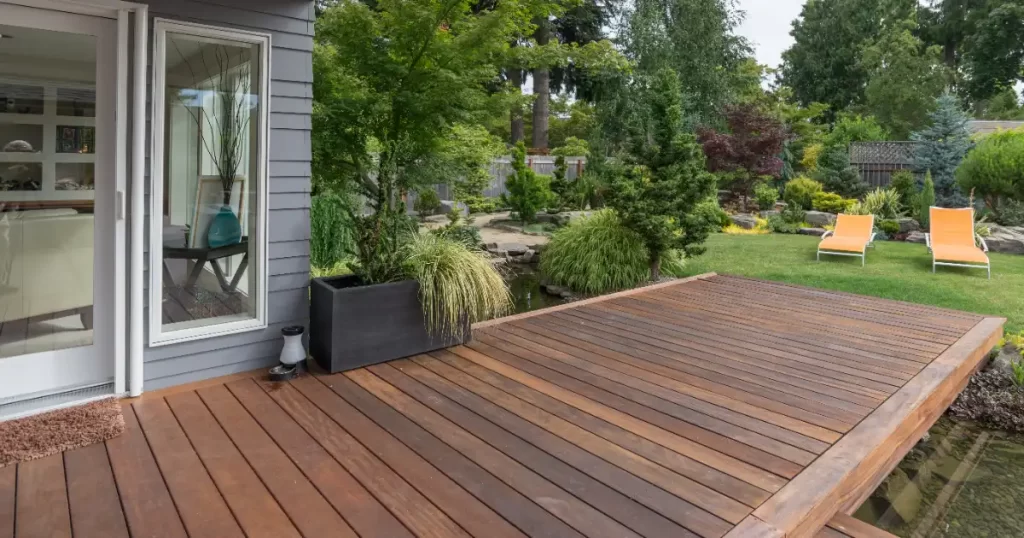 a floating deck in a landscaped backyard
