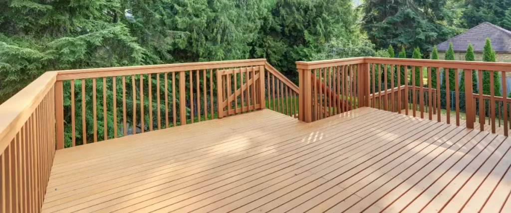an elevated outdoor area featuring a wooden deck and railings