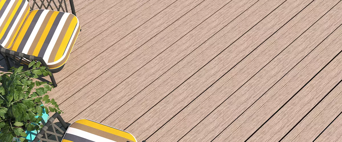 A close-up detail shot of durable composite wood deck planks and a sturdy dark metal railing in a contemporary home design.