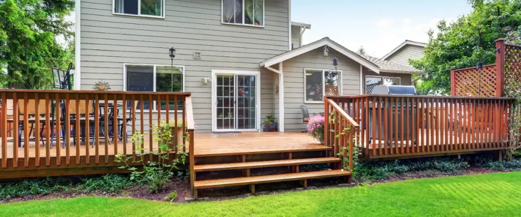 the exterior of a house featuring a large, multi-level wooden deck