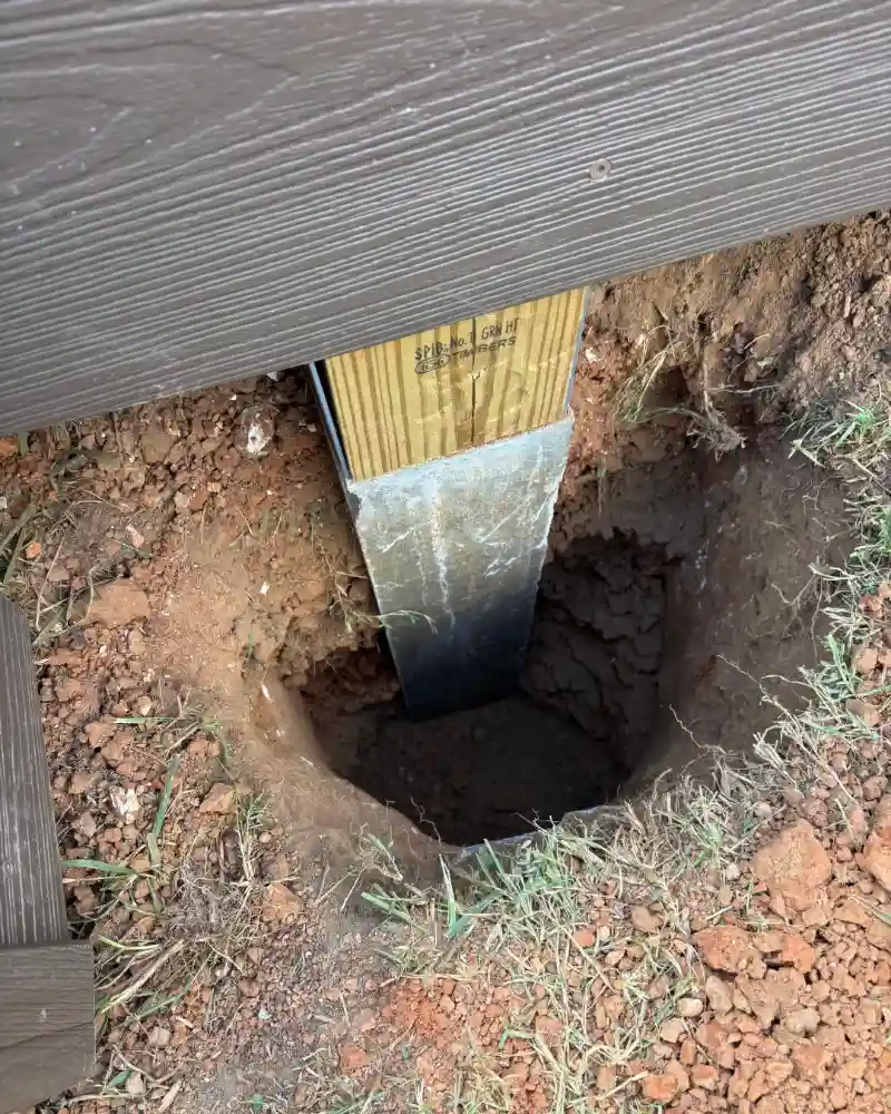 a deck support post set below ground level