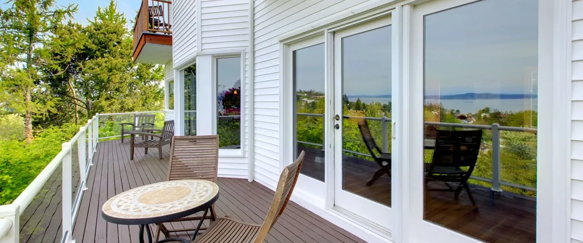 Modern backyard deck featuring sturdy wooden railings and custom-built stairs.
