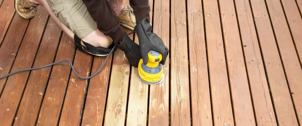 Professional deck maintenance tools and a clean wooden surface ready for spring weather preparation.