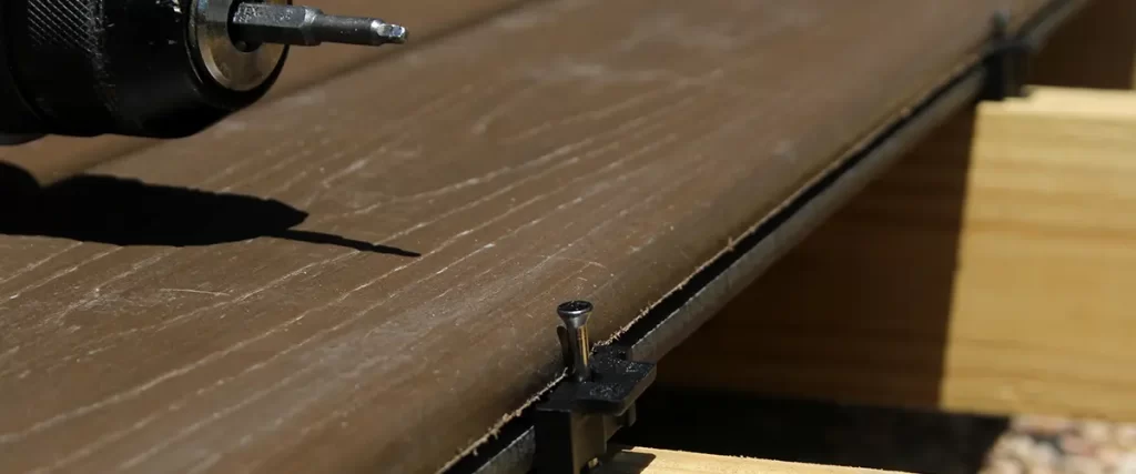 Close-up of hidden fastener system for composite deck board installation and framing