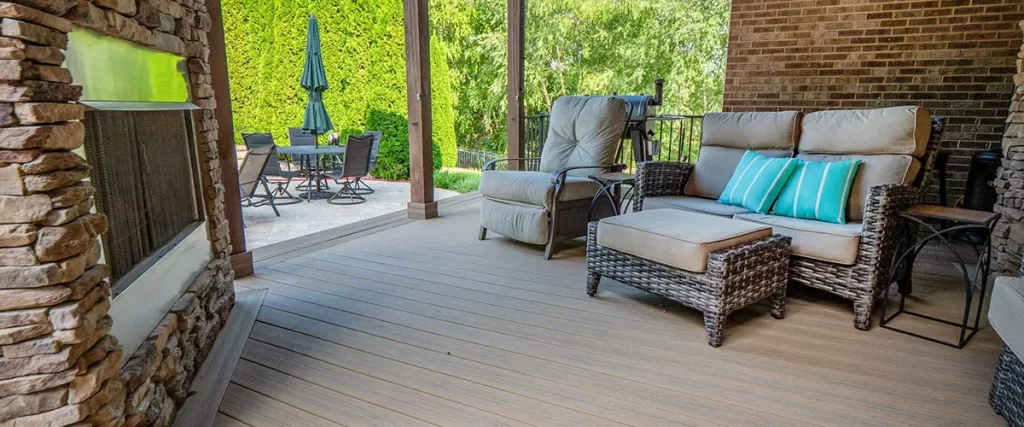 Covered outdoor living deck with fireplace, composite flooring and luxury patio seating area